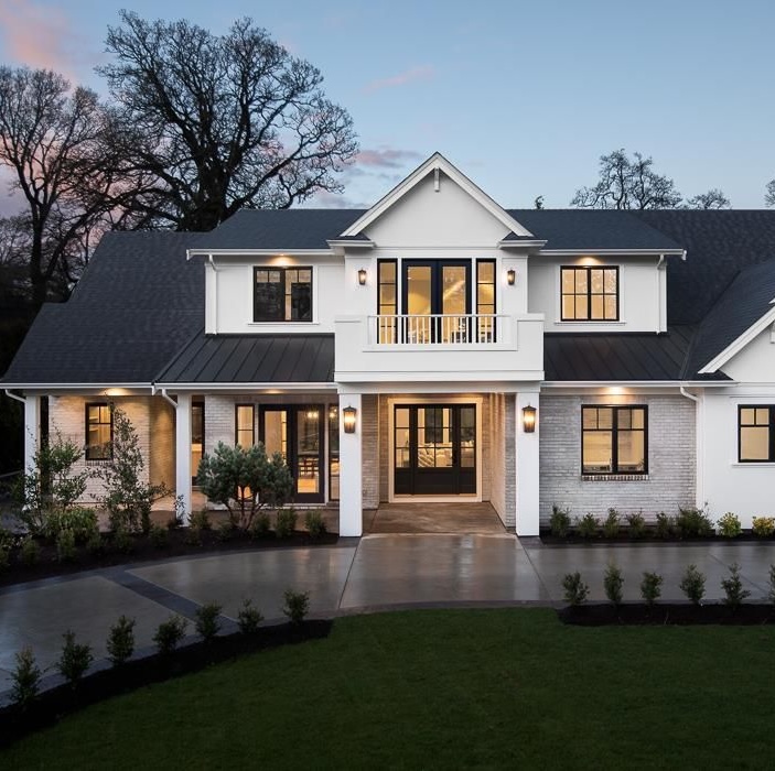 White two-storey home at dusk